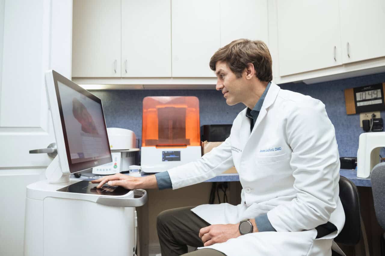 Dr. Jeremy Ledford of Asheville Dental using advanced dental technology in the office, showcasing modern equipment for patient care and treatment.